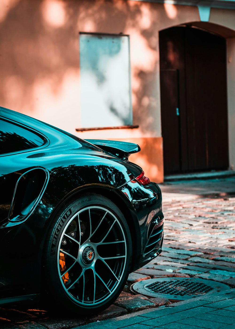 a black sports car parked in front of a building