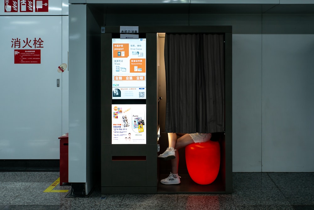 a red chair sitting in a room next to a door