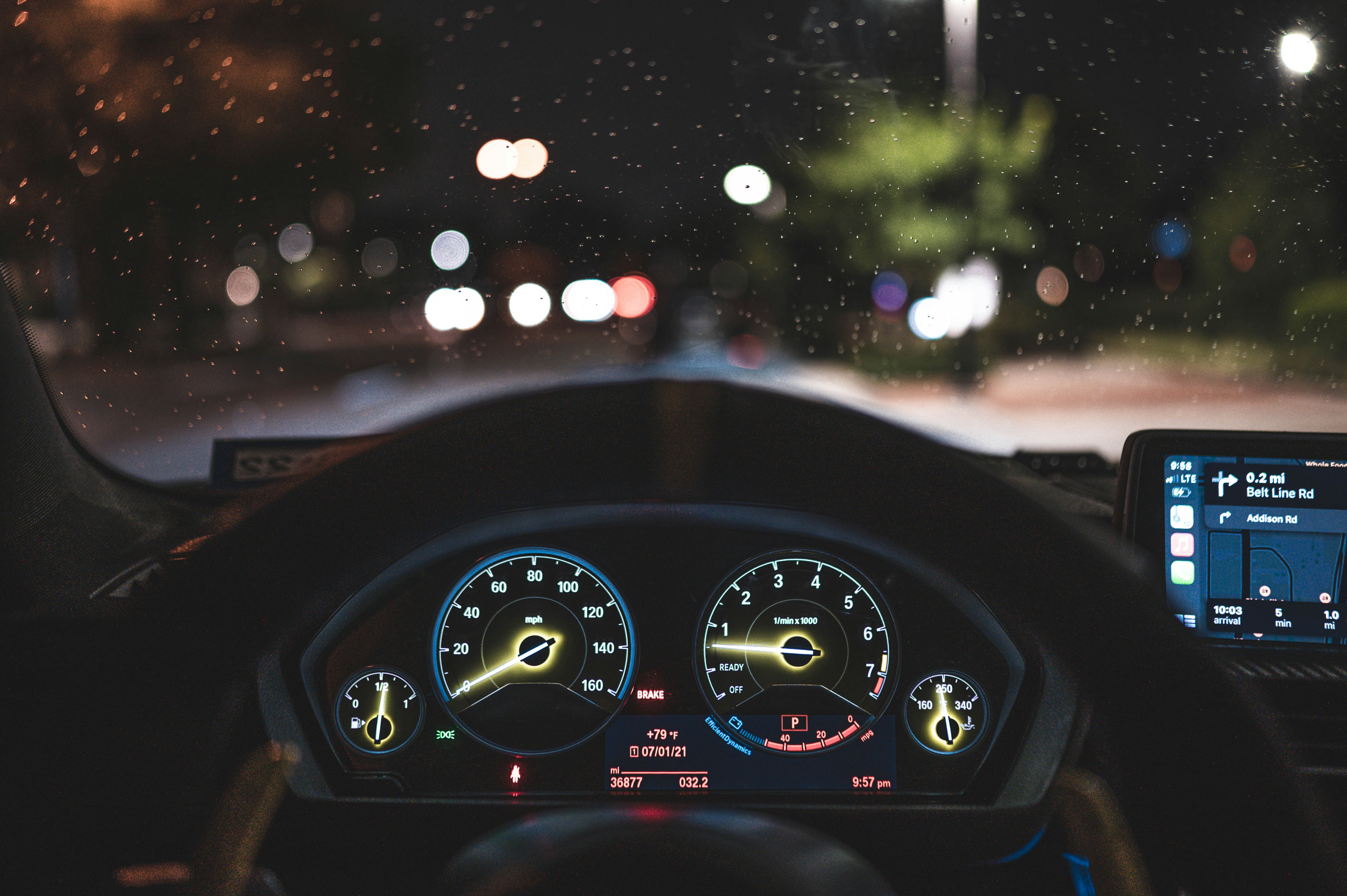 the dashboard of a car at night time