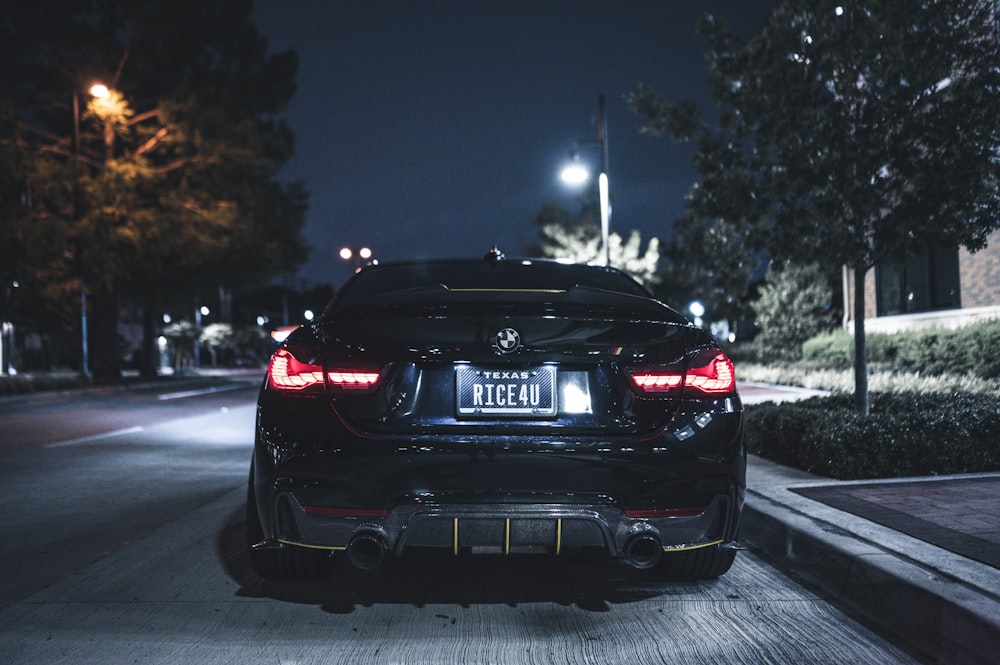 a car parked on the side of the road at night