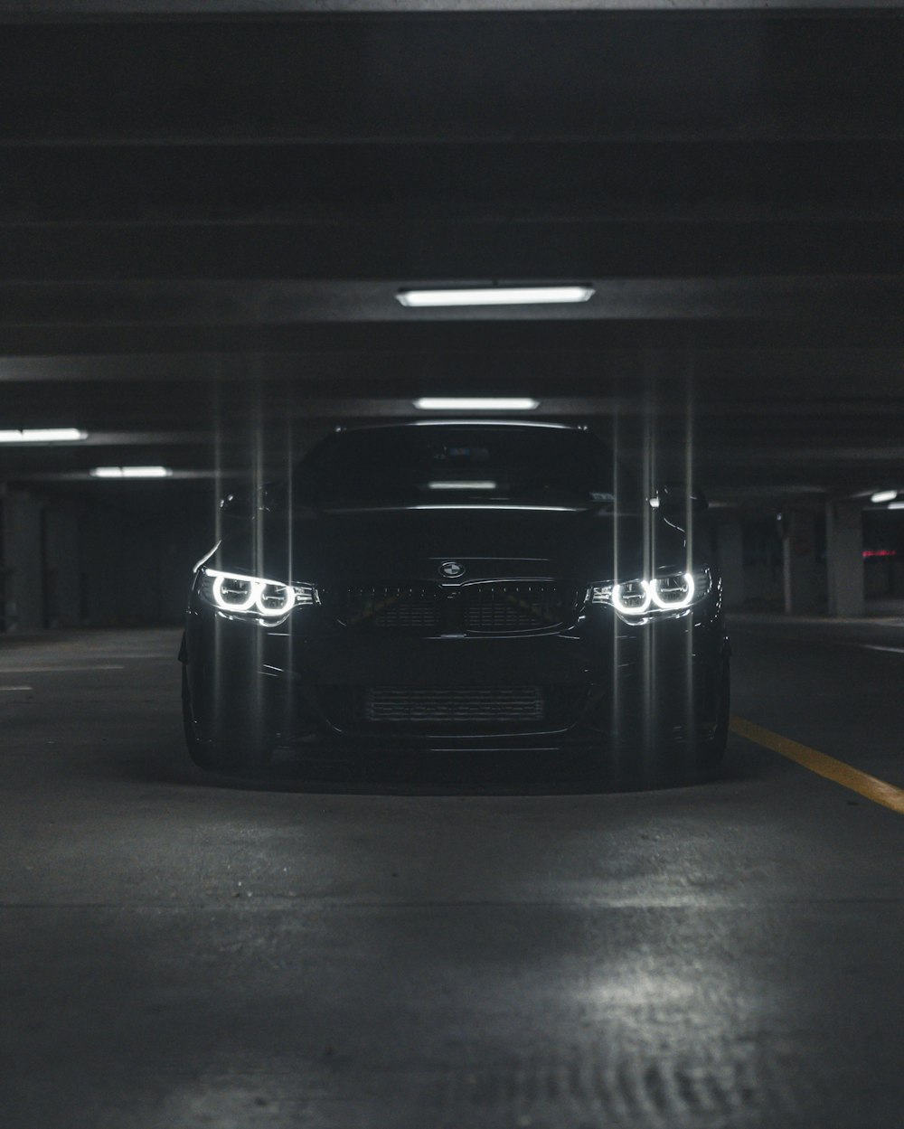 a black car parked in a parking garage