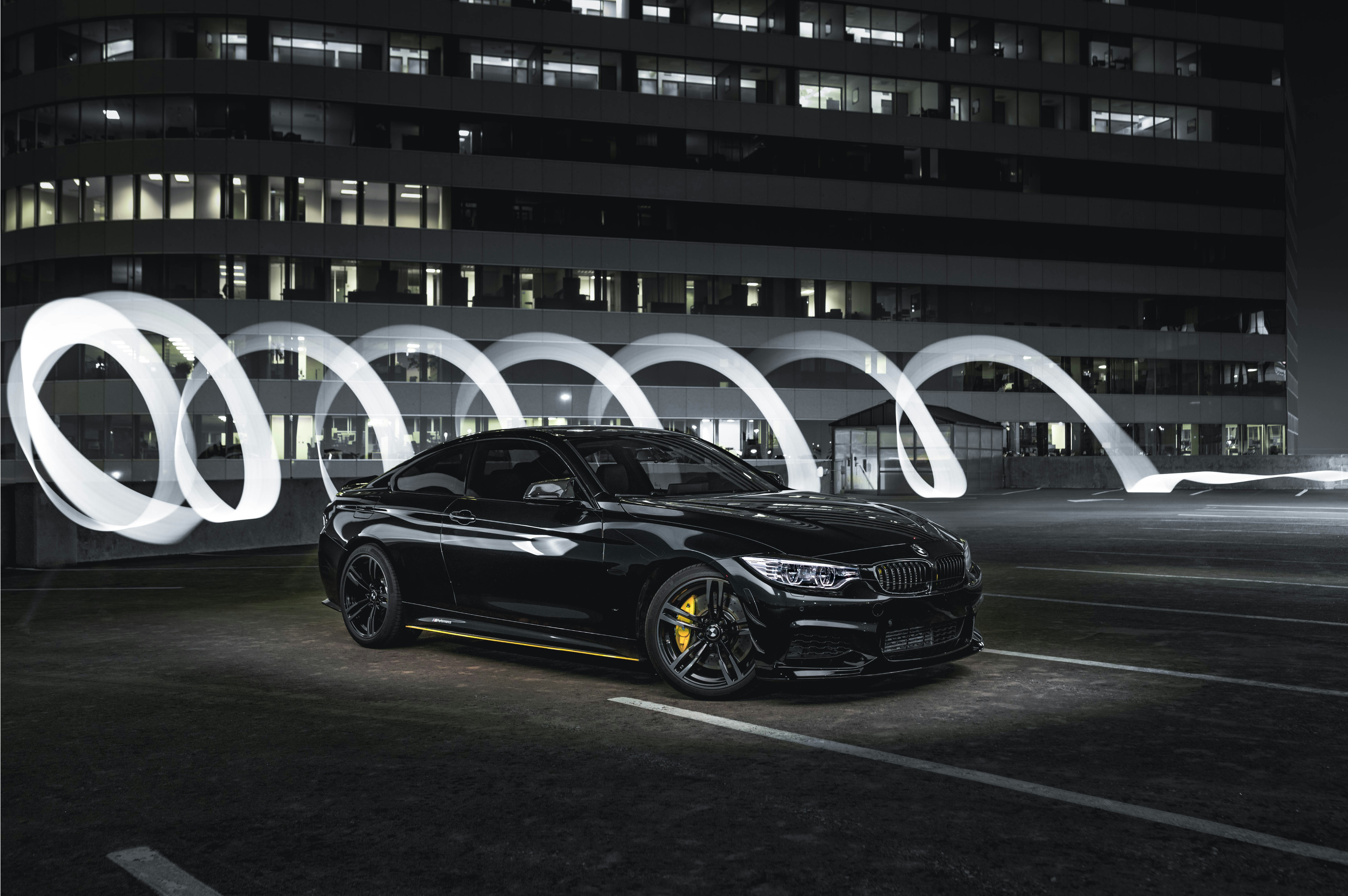 a black car parked in front of a tall building