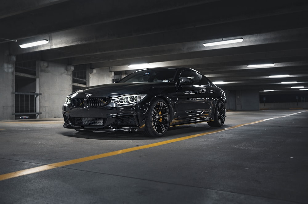 a black car parked in a parking garage