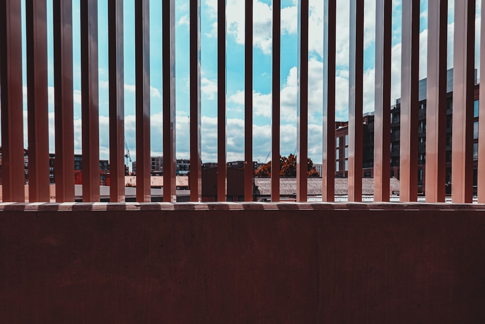 a bench sitting in front of a wooden fence