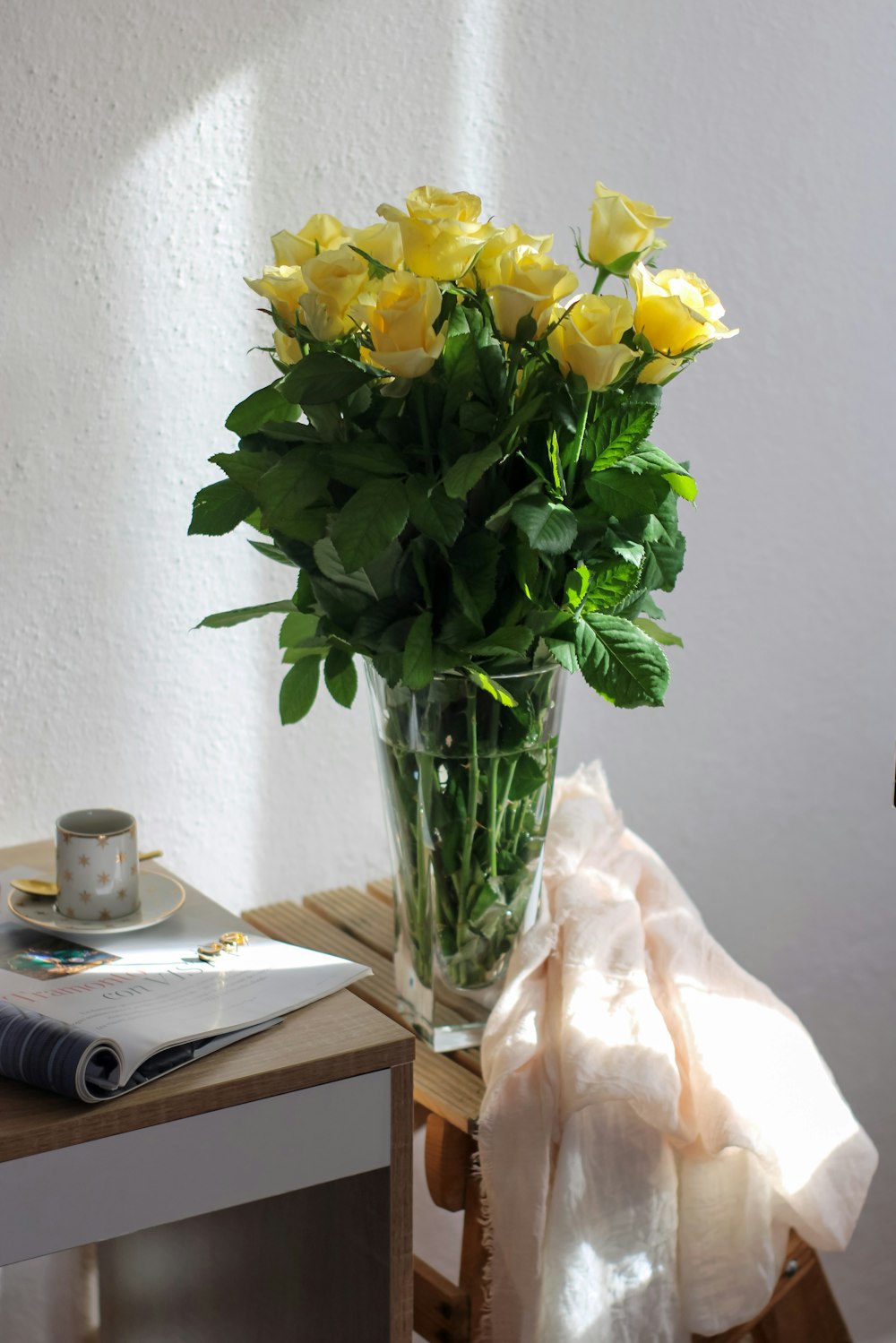 a vase filled with yellow flowers on top of a table