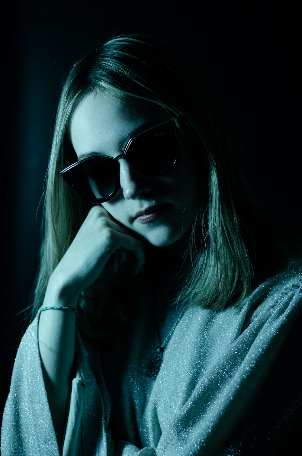 a woman wearing sunglasses is posing for a picture