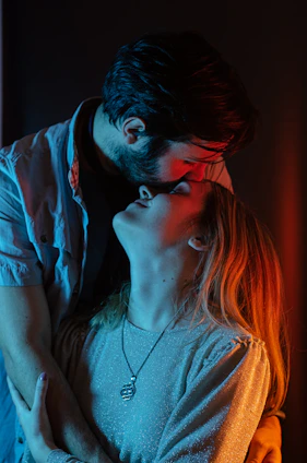 a man and a woman kissing in the dark