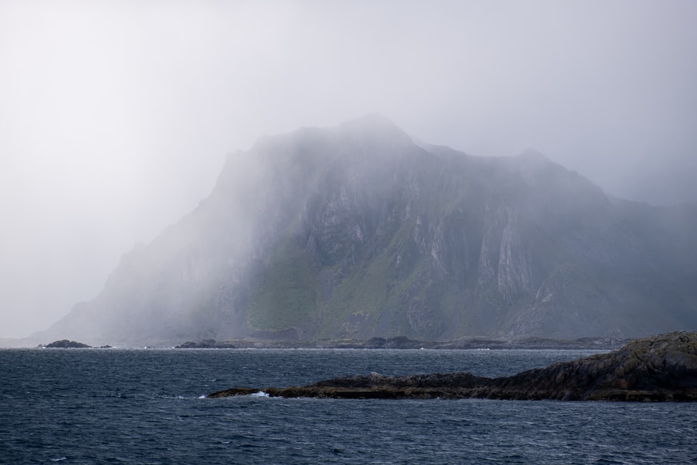 a large mountain in the middle of a body of water