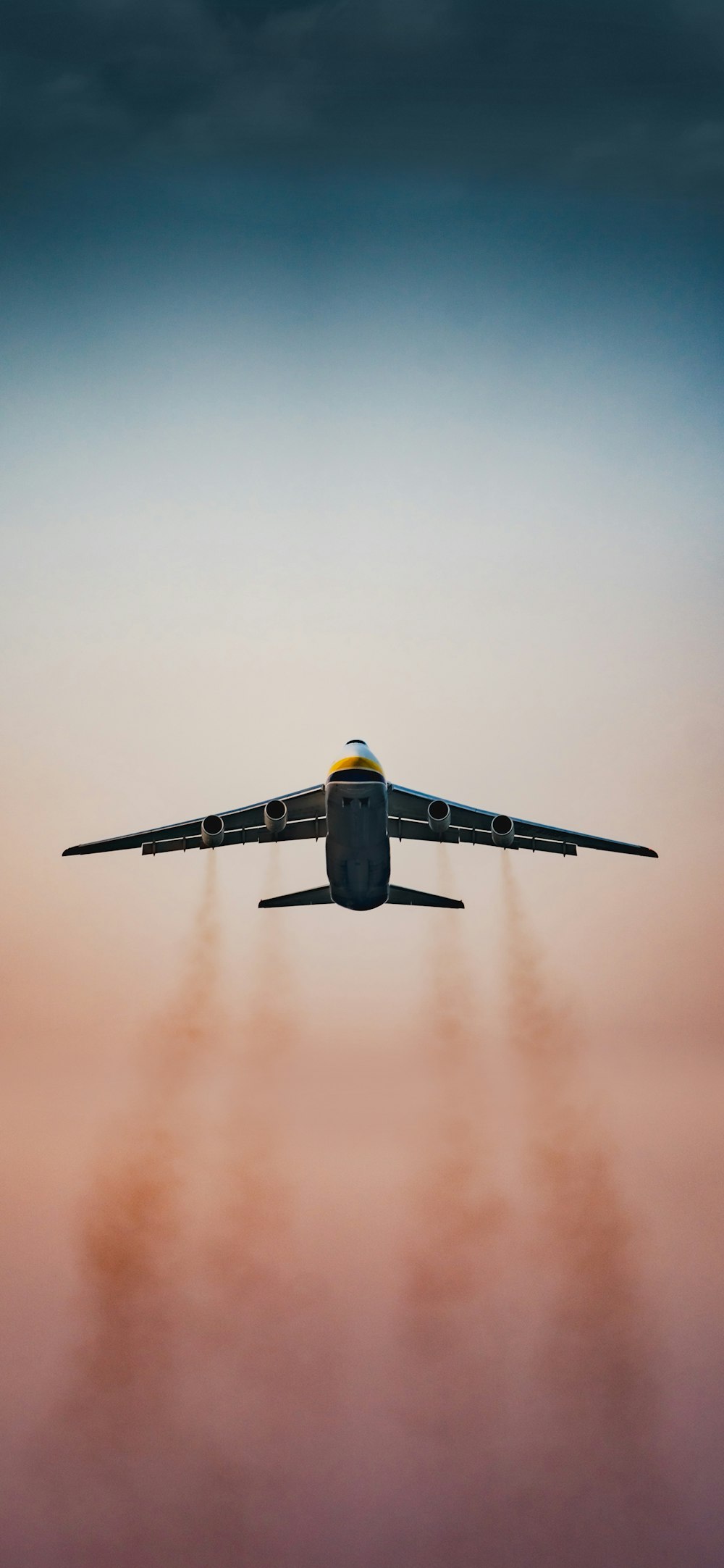 a large jetliner flying through a cloudy sky