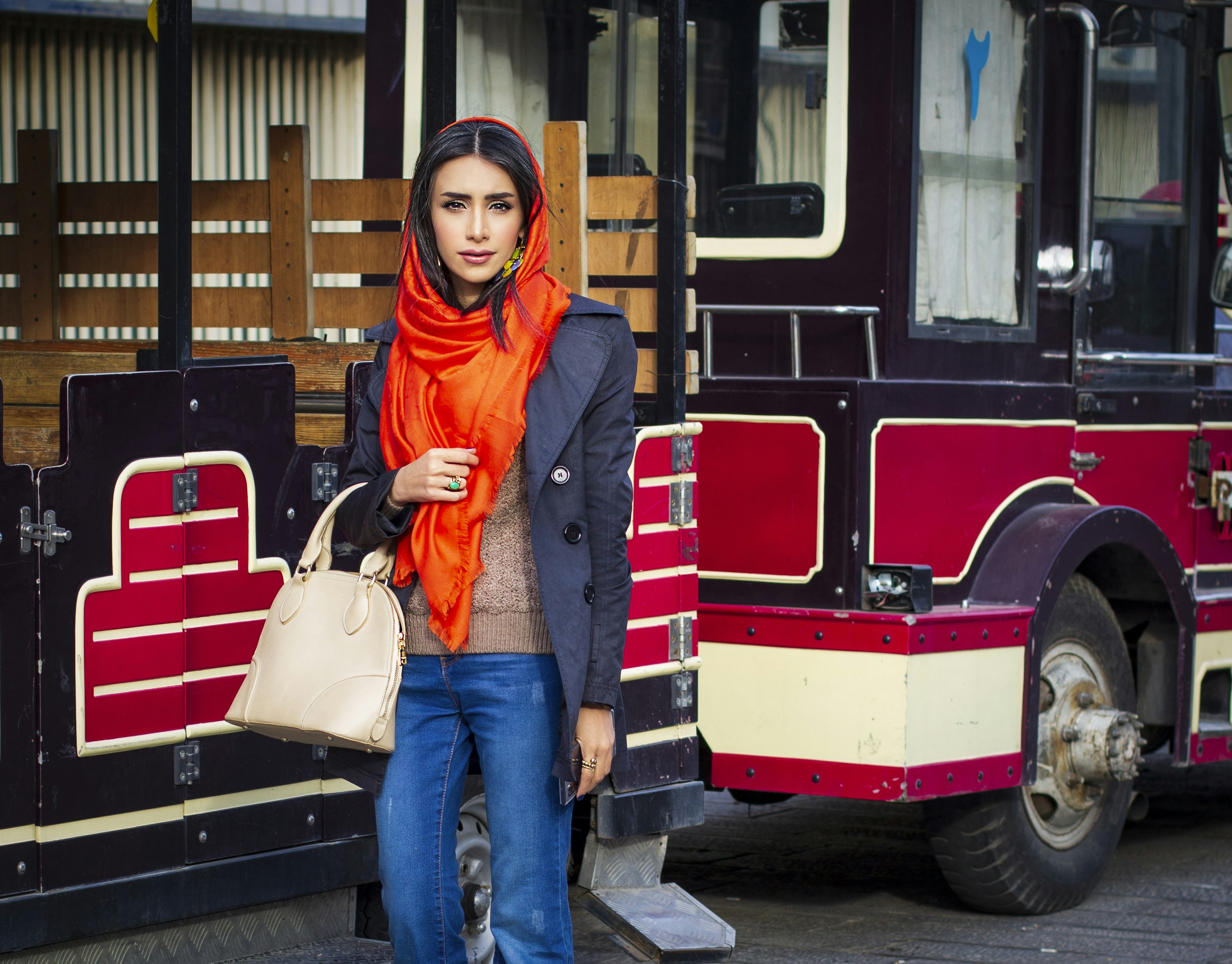 a woman standing in front of a bus