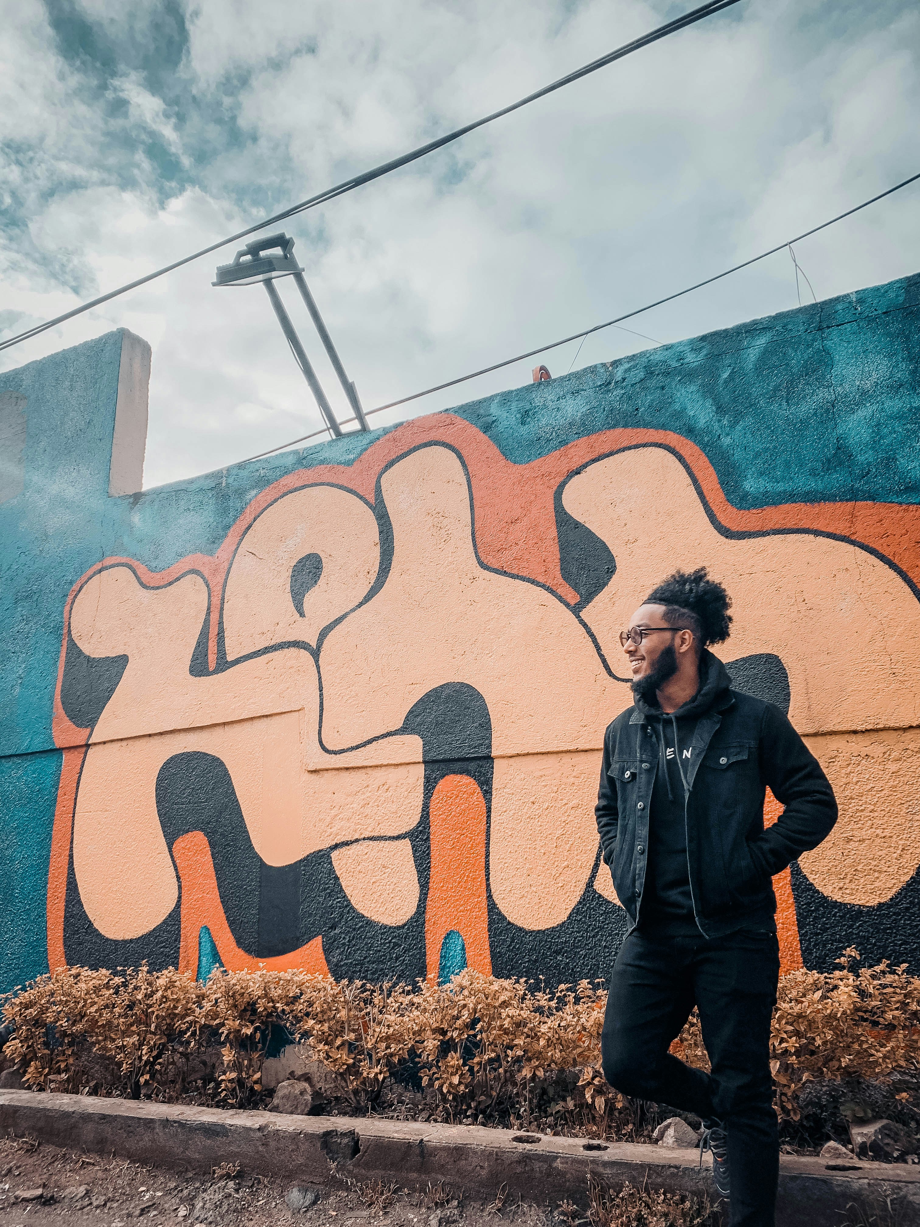 a man standing in front of a colorful wall