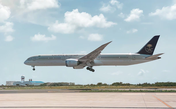 A sleek, modern illustration showing a seamless connection between travel agencies and ground services in Saudi Arabia.