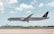 An aircraft from Saudia airlines is in mid-air, about to land at an airport. The background features a clear sky with scattered fluffy clouds. Below the plane, there is a runway and some airport buildings with a radar dome.