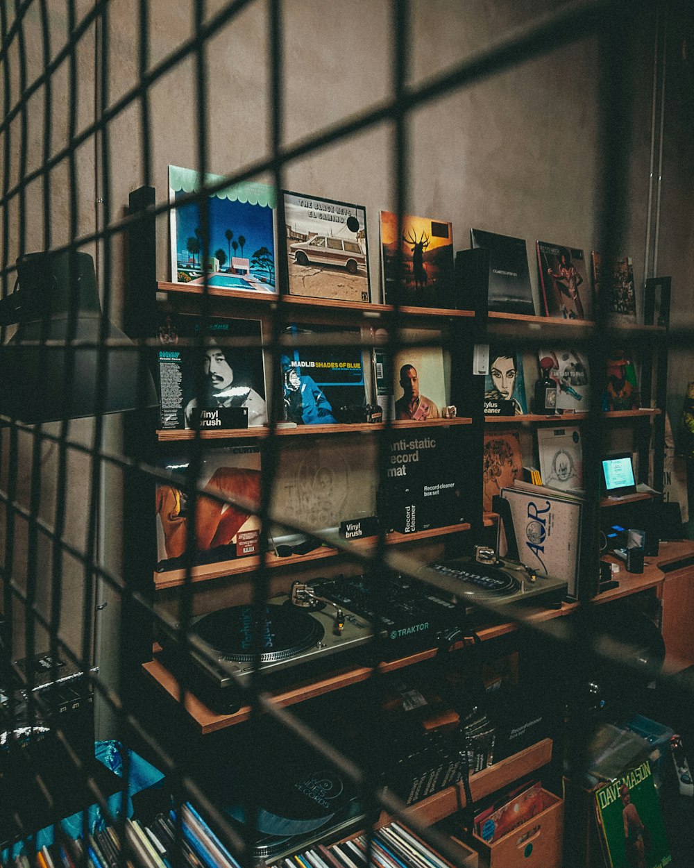 a room with a lot of books and cds on a shelf