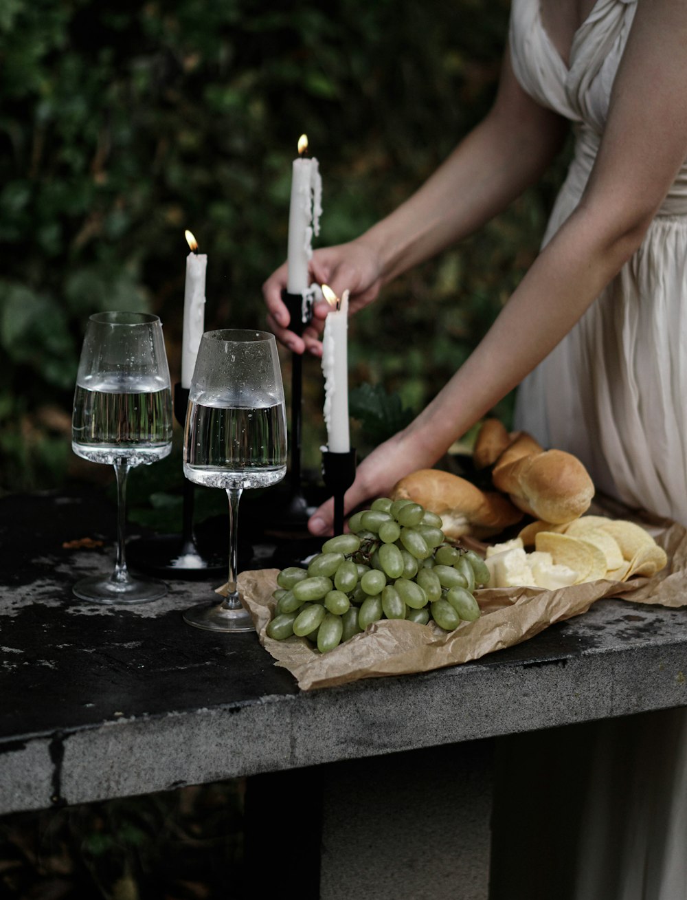 a woman in a white dress holding a bottle of wine