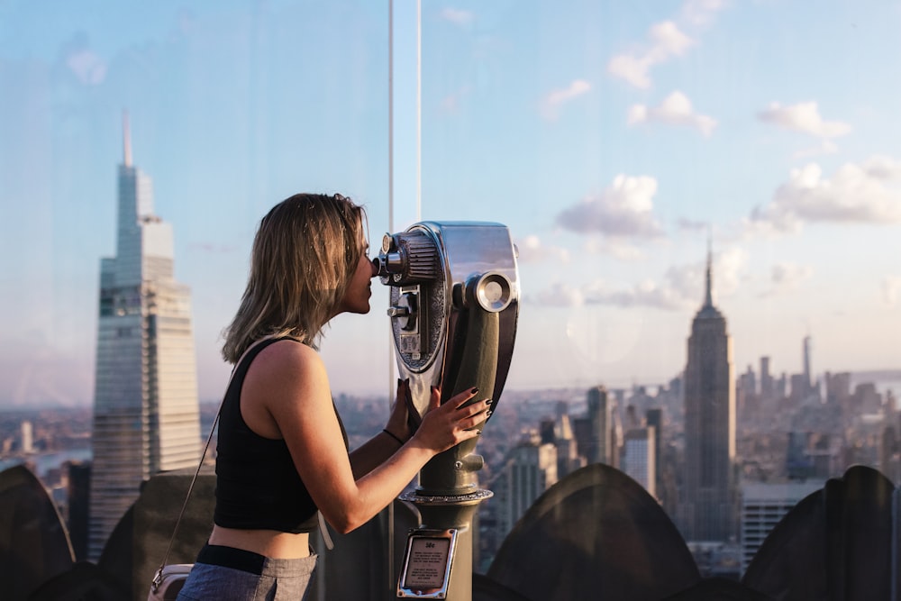 a woman looking through a pair of binoculars