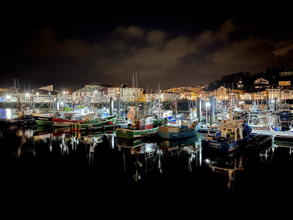 a harbor filled with lots of boats at night