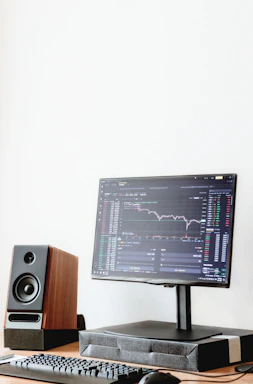 a computer monitor sitting on top of a wooden desk