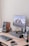 a computer desk with a keyboard, mouse, speakers and a monitor