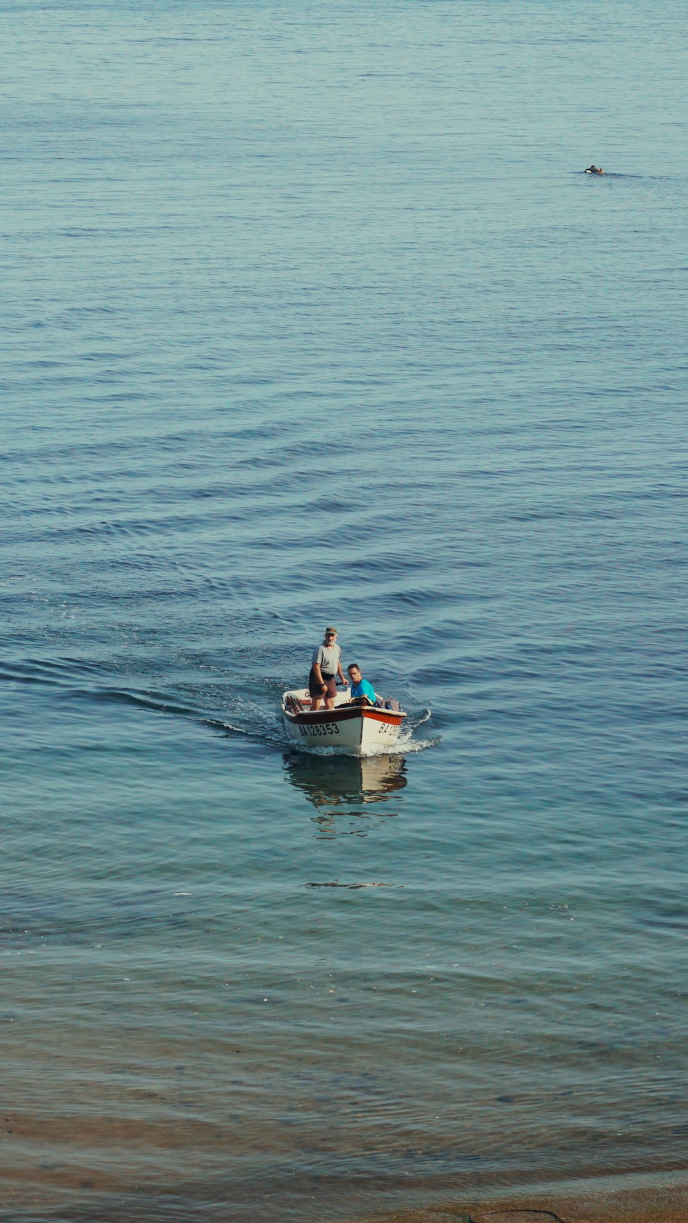 two people in a small boat on the water