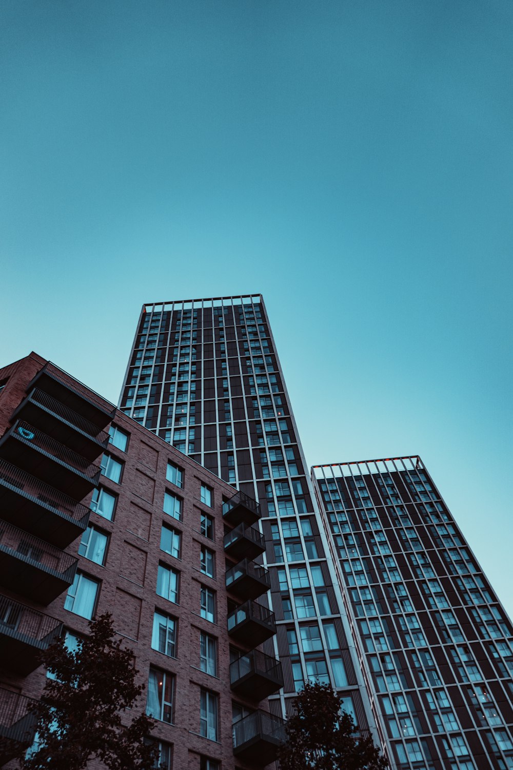 a tall red brick building next to a tall red brick building