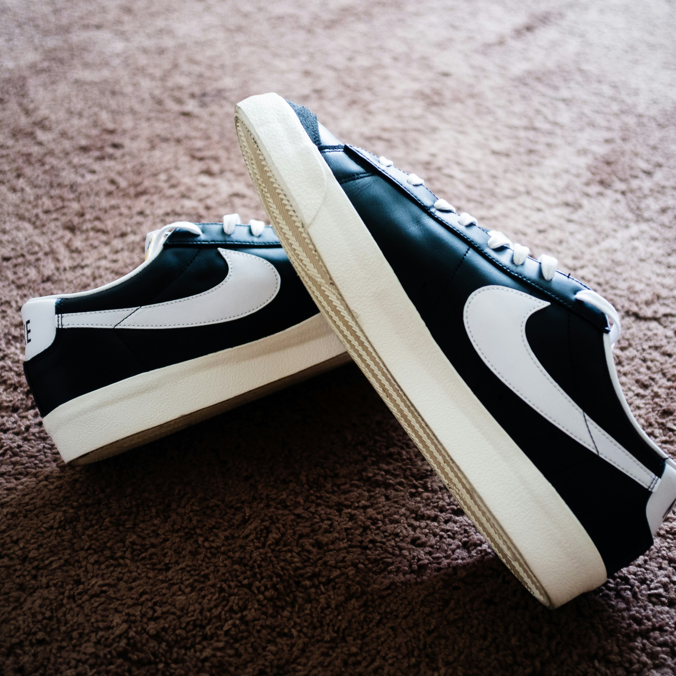 a pair of black and white nike sneakers