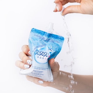 a person is holding a bottle of water