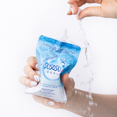 a person is holding a bottle of water