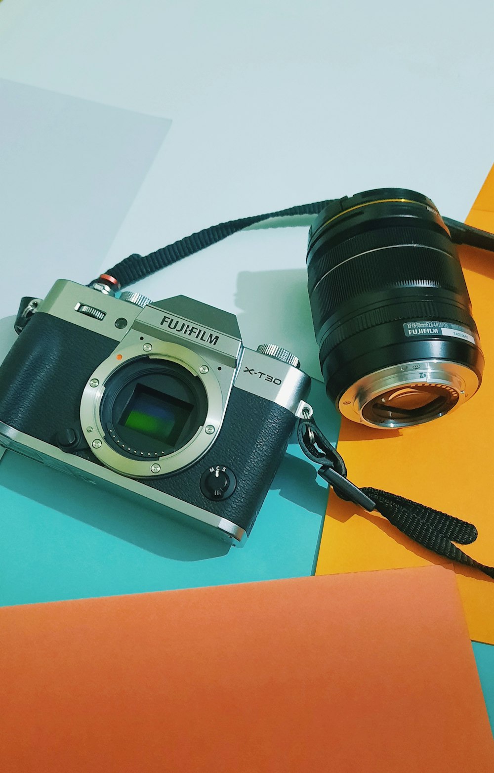 a camera sitting on top of a table next to a lens