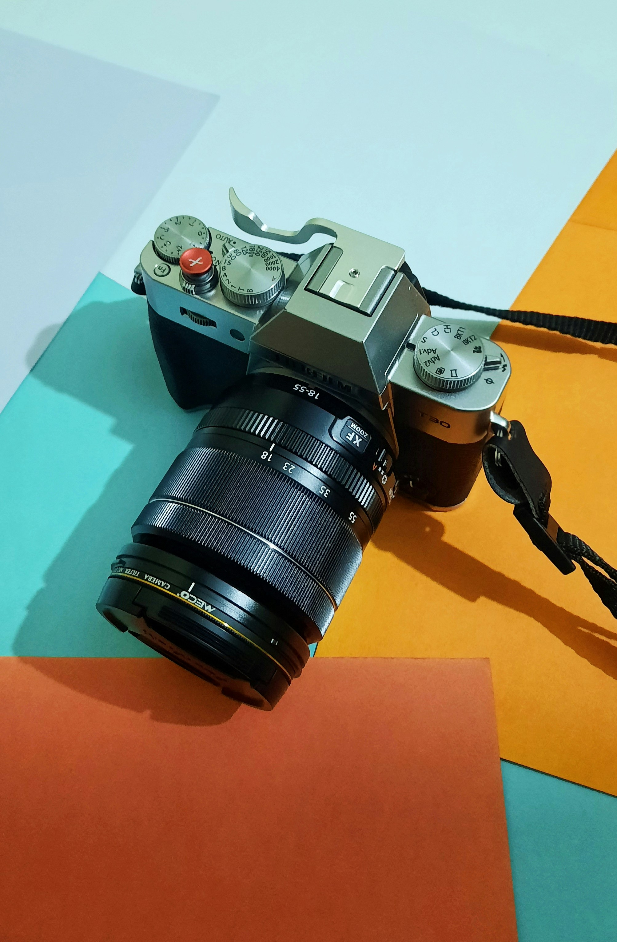 a camera sitting on top of a colorful surface