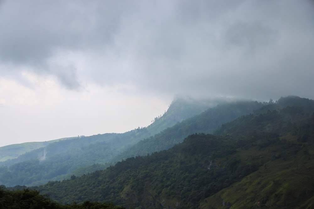 a view of a mountain range with low clouds