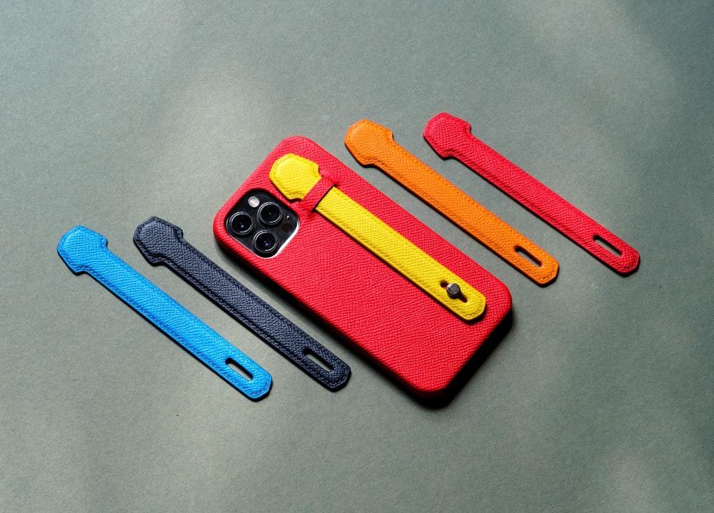 three different colored cases sitting on top of a table