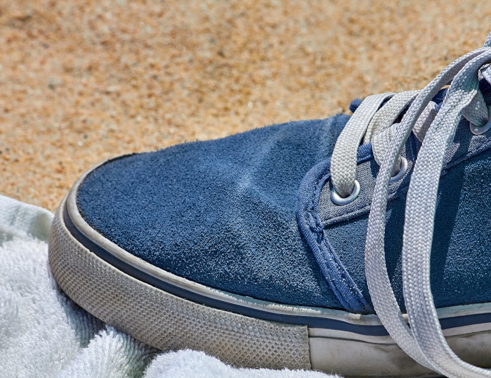 a close up of a blue shoe on a towel