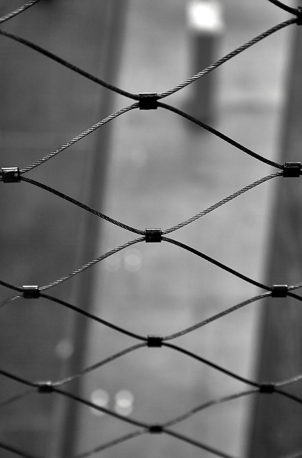 a black and white photo of a wire fence