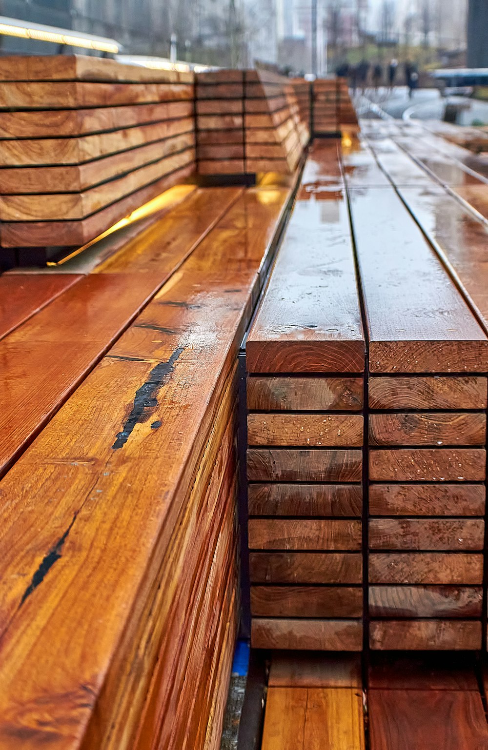 a row of wooden benches sitting next to each other