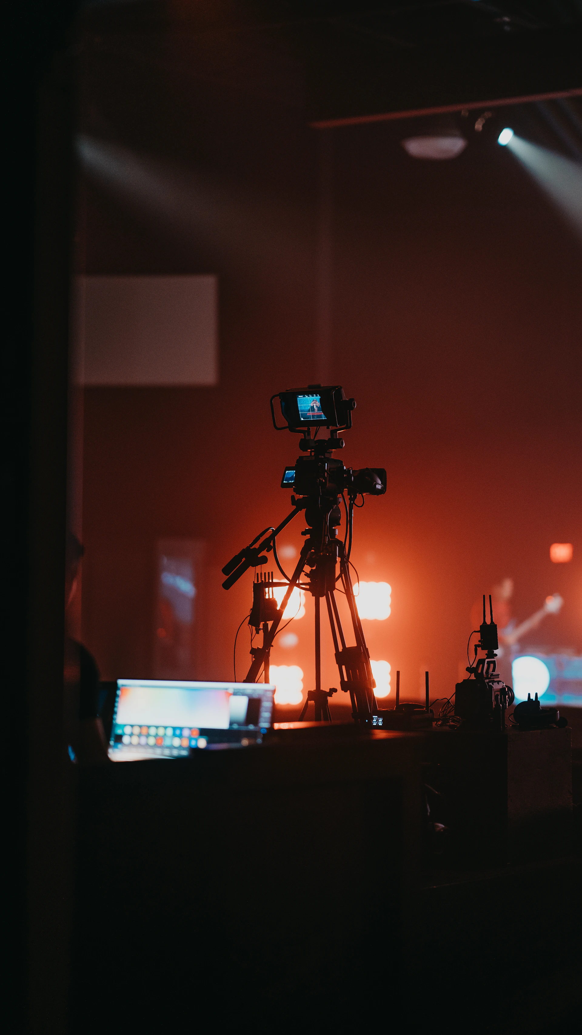 a camera set up on a tripod on a stage