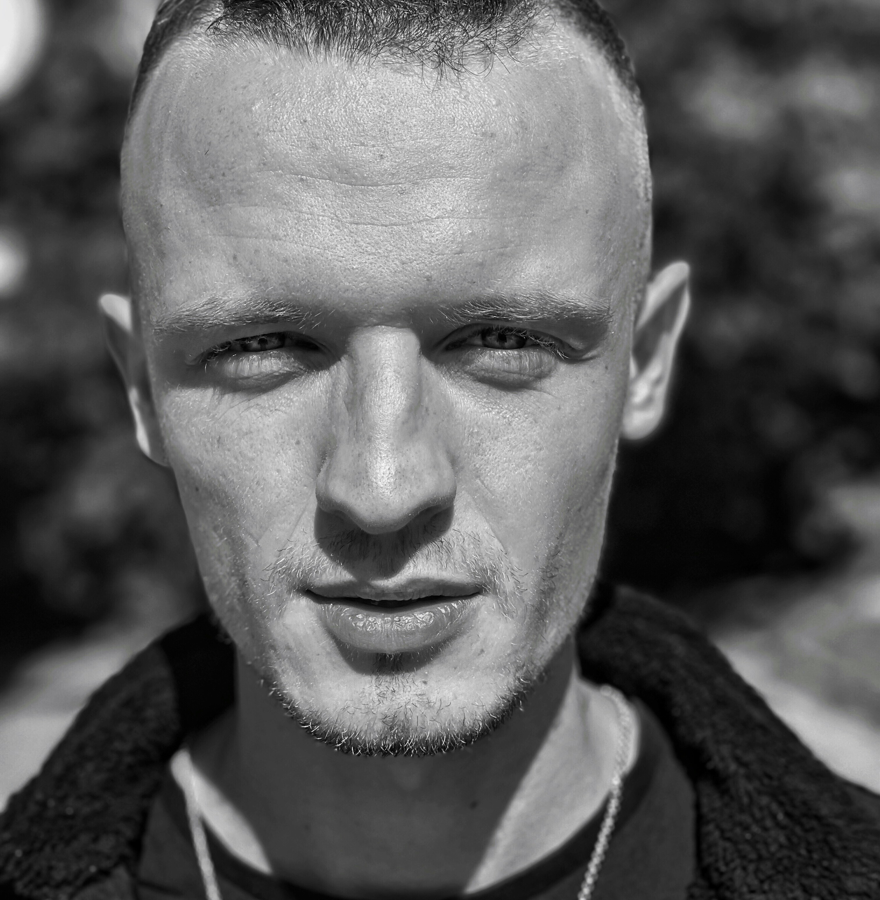 a black and white photo of a man with a bald head