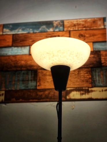 A soft nordic floor lamp casting a gentle glow in a cozy living room corner.