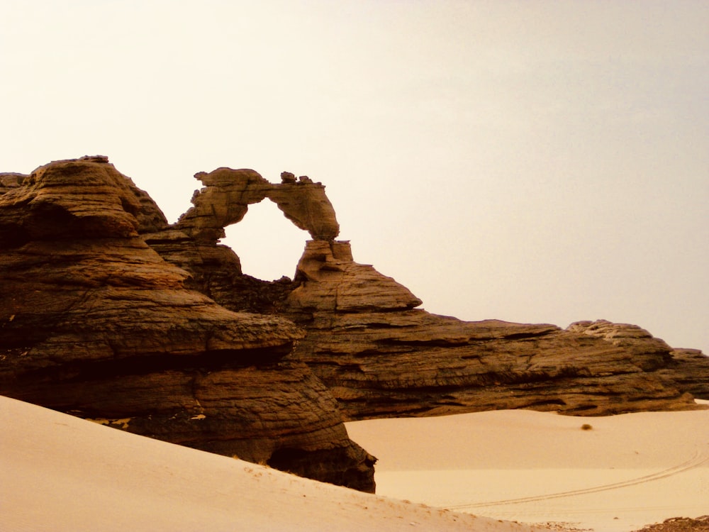 a large rock formation in the middle of a desert