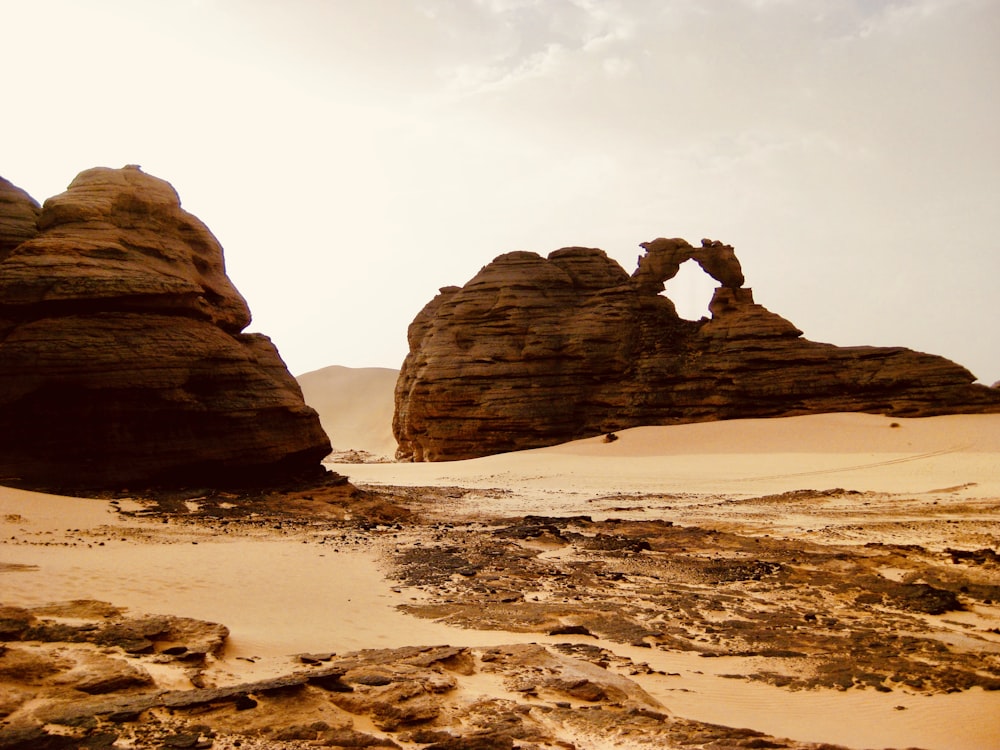 a desert scene with rocks and sand in the foreground