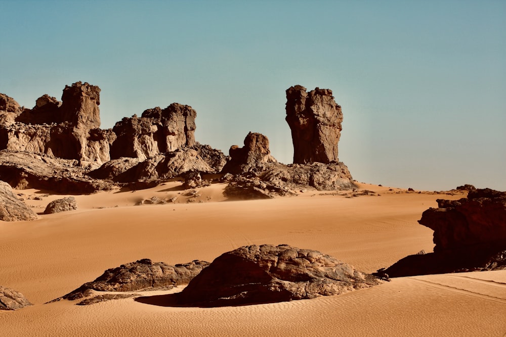 a desert scene with rocks and sand in the foreground