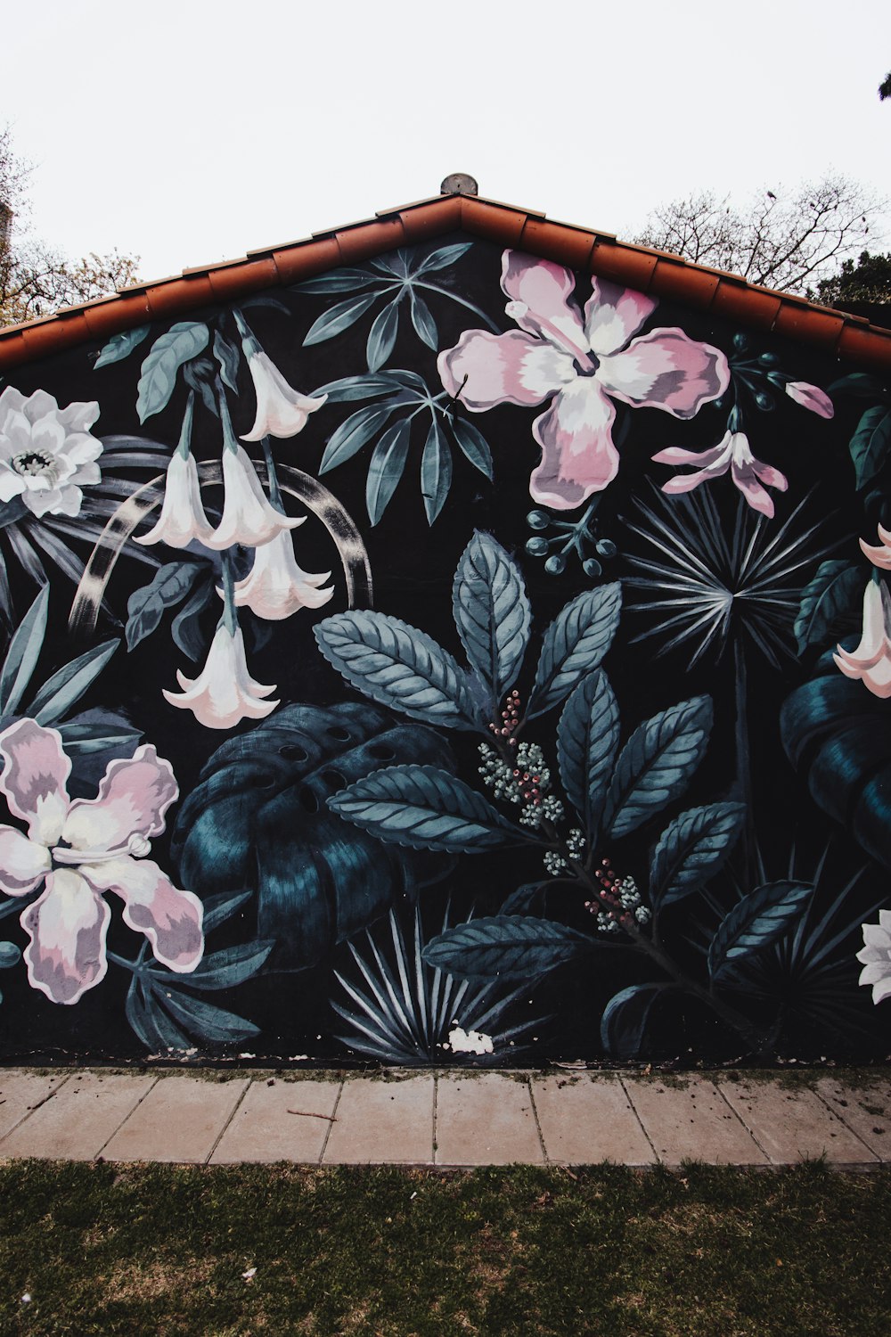 a mural of flowers painted on the side of a building