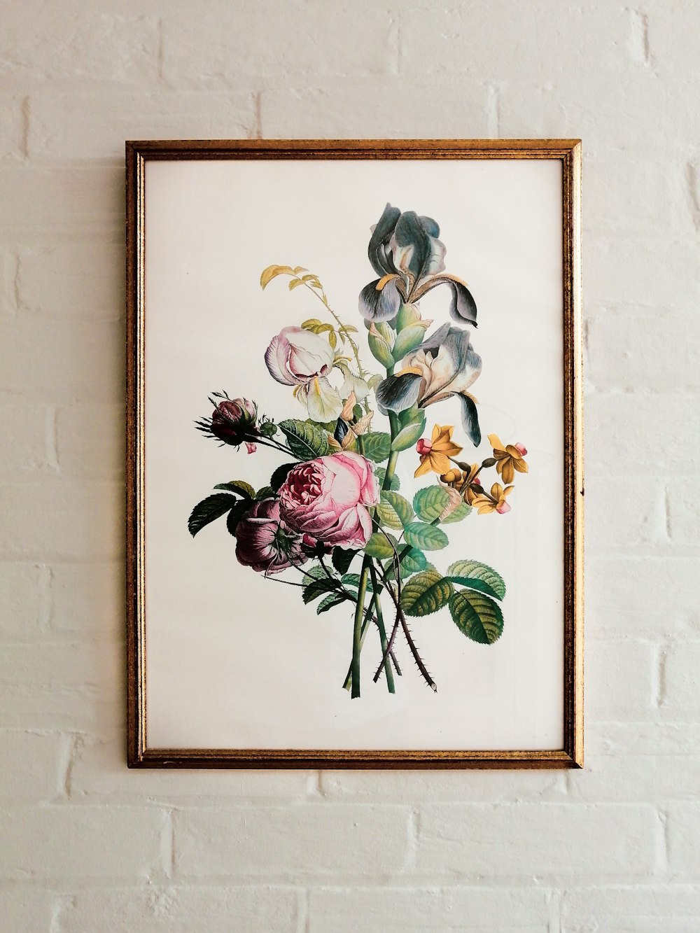 a picture of a bunch of flowers hanging on a wall