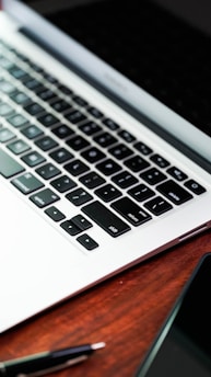 a laptop computer sitting on top of a wooden desk