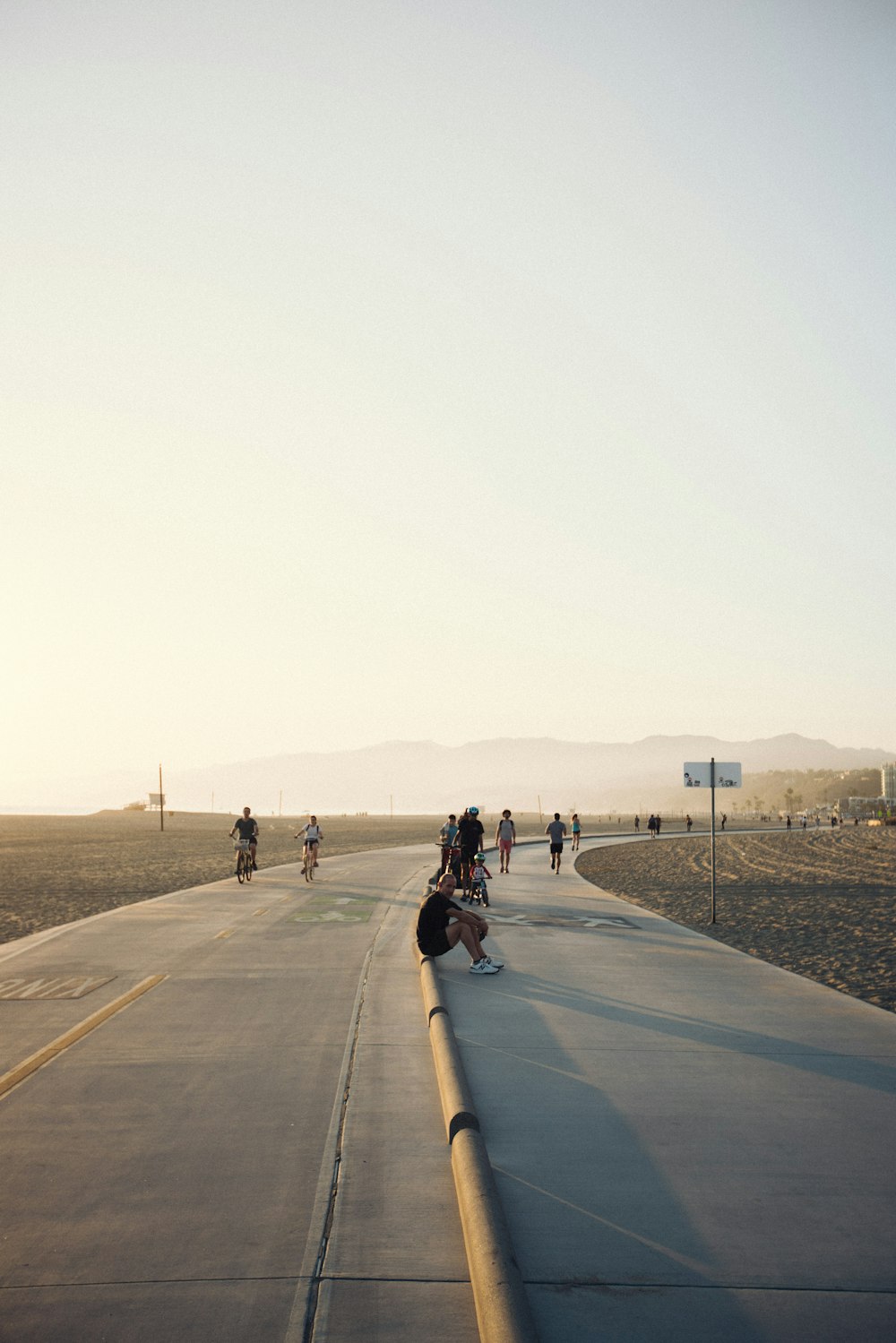 a group of people riding bikes down a road