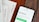 A wooden table with several documents and a smartphone. The documents are titled 'User Persona', 'Brand Colours', and 'Sprintpoint'. The smartphone displays a webpage for 'Sprintpoint', which offers strategy tools for growing businesses.