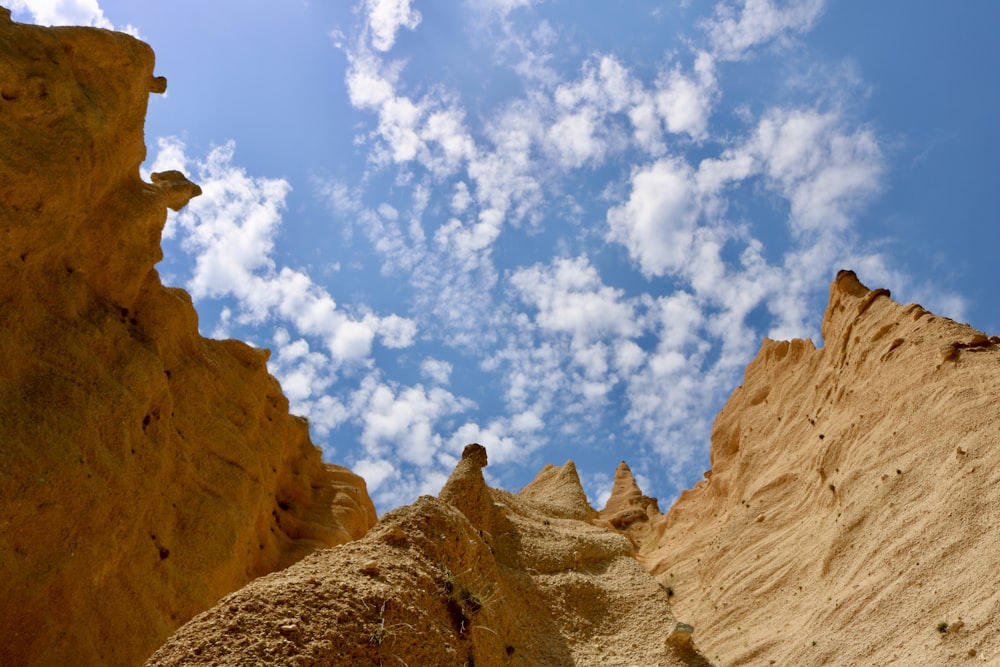 a blue sky with some clouds above some rocks