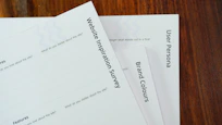 a close up of a stack of papers on a table