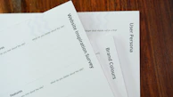 a close up of a stack of papers on a table