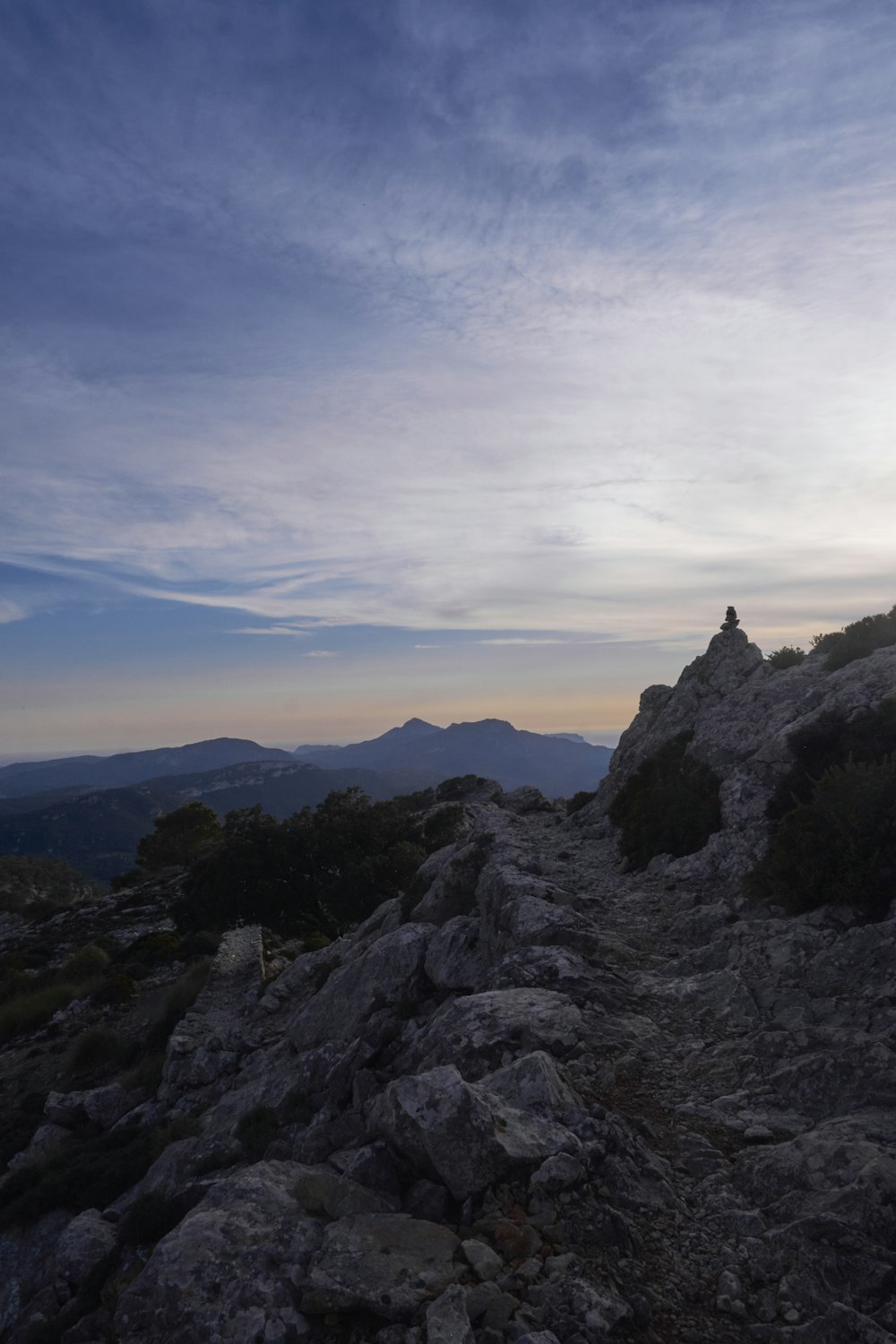 a person standing on top of a rocky hill